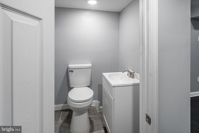 bathroom with vanity, toilet, and tile patterned flooring