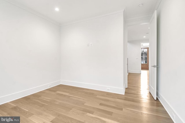 unfurnished room featuring crown molding and light hardwood / wood-style floors