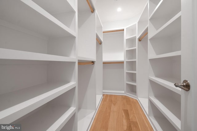 walk in closet featuring light hardwood / wood-style flooring