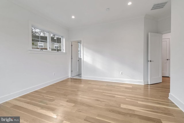 empty room with light hardwood / wood-style flooring