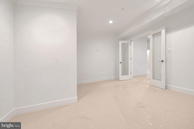 carpeted spare room with french doors