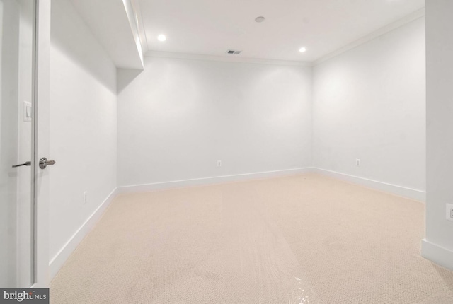 carpeted empty room featuring crown molding