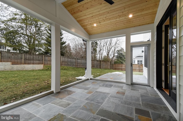 unfurnished sunroom featuring ceiling fan, lofted ceiling, and wood ceiling