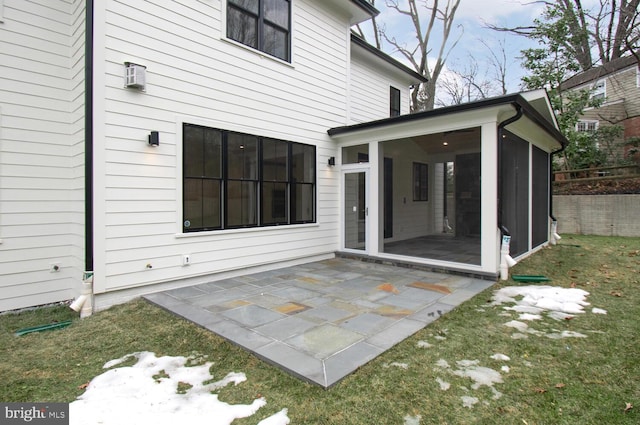 back of house with a yard, a patio area, and a sunroom