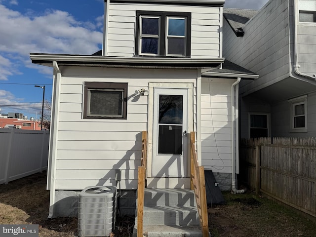 back of house with central AC unit