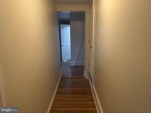 corridor with dark hardwood / wood-style floors