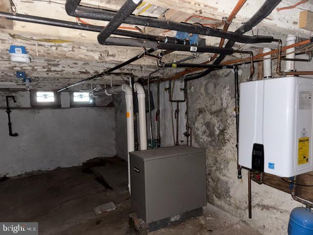 basement featuring tankless water heater