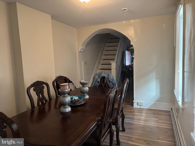 dining space featuring hardwood / wood-style flooring and a baseboard radiator