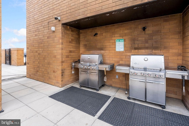 view of patio featuring area for grilling and a grill