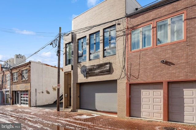 snow covered property featuring a garage