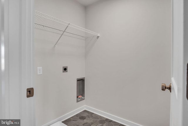 laundry area with baseboards, hookup for an electric dryer, and laundry area