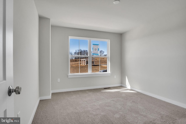 carpeted empty room with baseboards