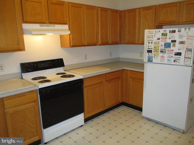 kitchen with white fridge and electric range oven