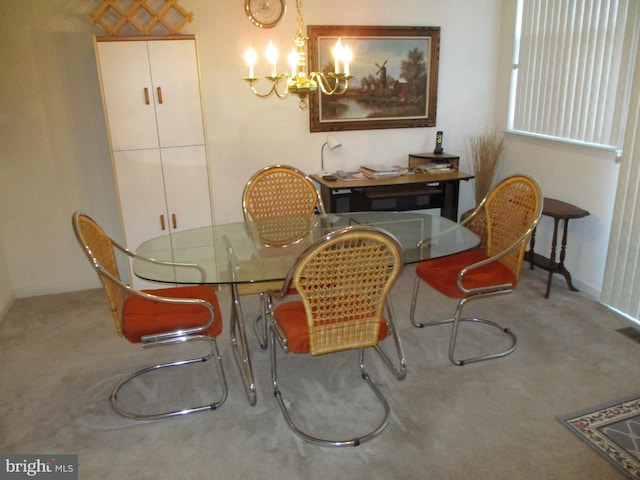 carpeted dining room with a chandelier