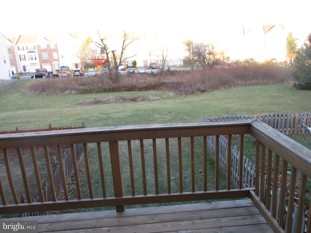 wooden terrace featuring a yard