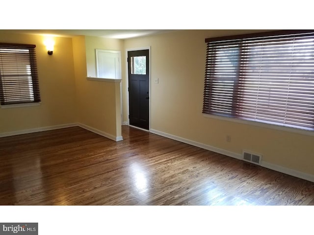 foyer with dark hardwood / wood-style floors