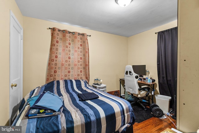 bedroom with hardwood / wood-style flooring