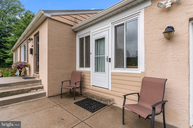 property entrance featuring a patio area