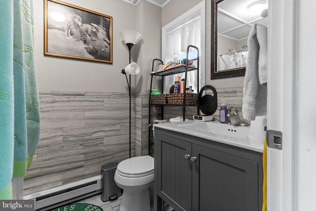 bathroom featuring a baseboard radiator, vanity, toilet, and tile walls