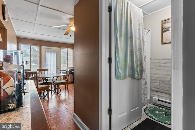 bathroom featuring ceiling fan, tile patterned flooring, and a drop ceiling