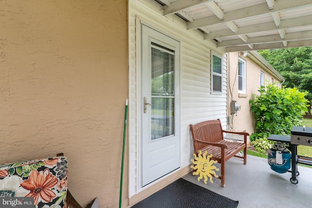 entrance to property featuring a patio