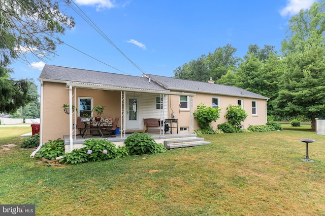 back of house featuring a lawn