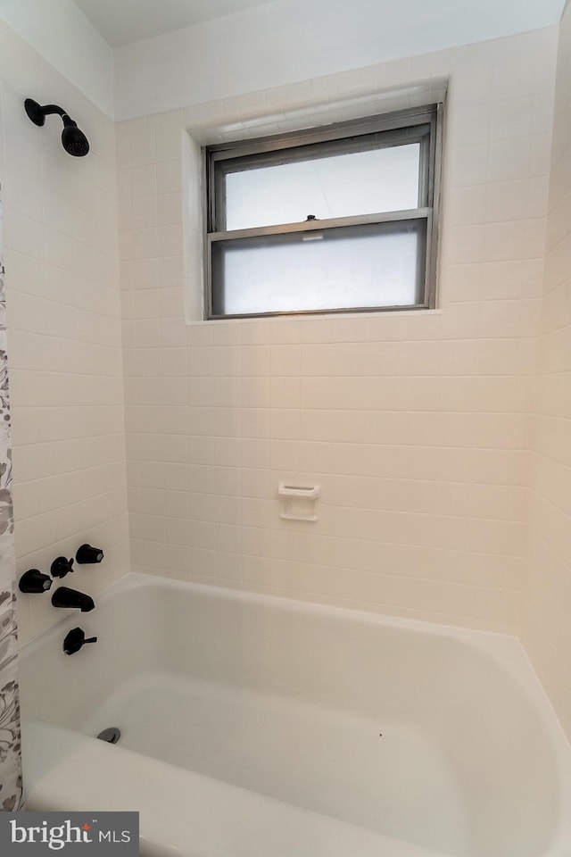 bathroom with shower / bath combination with curtain