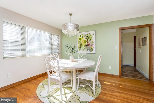 dining space with an inviting chandelier and hardwood / wood-style floors