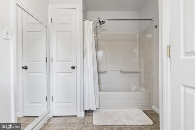 bathroom featuring shower / tub combo with curtain and tile patterned flooring