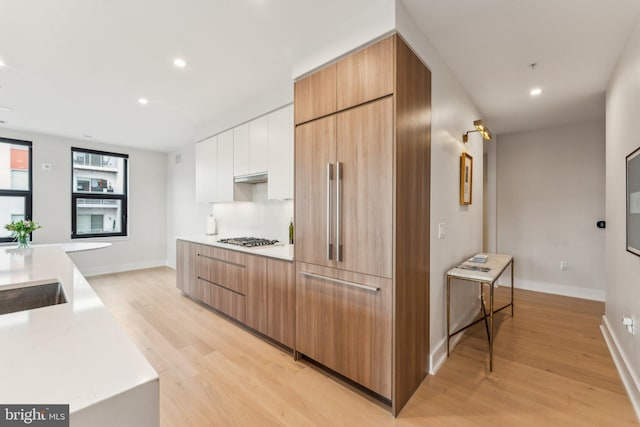 kitchen featuring white cabinetry, stainless steel gas cooktop, and light wood-type flooring