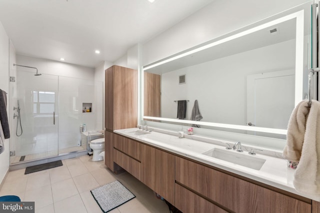 bathroom featuring tile patterned floors, toilet, a shower with shower door, and vanity