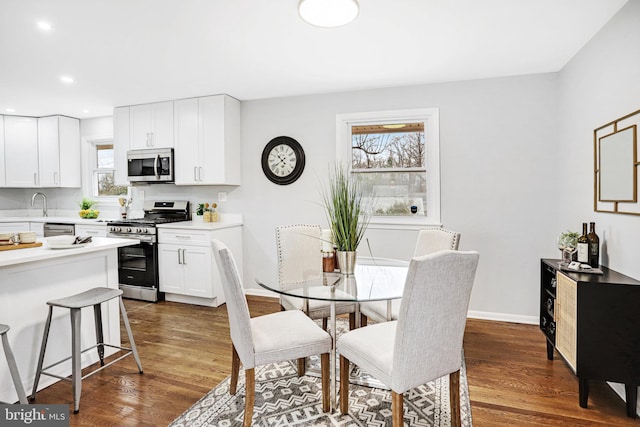 dining space with dark hardwood / wood-style floors