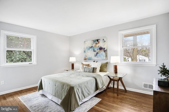 bedroom with dark wood-type flooring