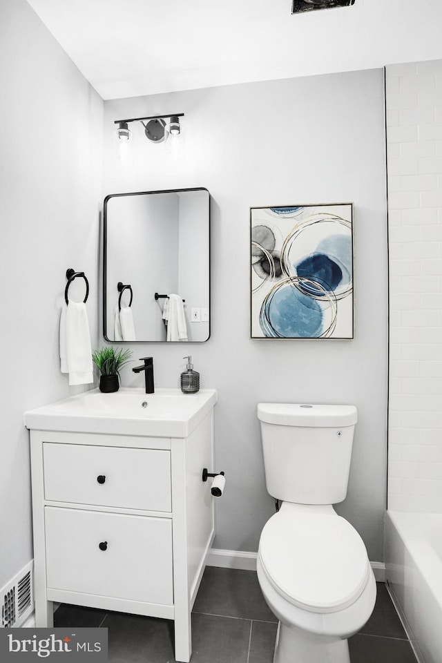 full bathroom with tile patterned floors, toilet,  shower combination, and vanity