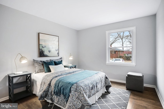 bedroom with dark wood-type flooring