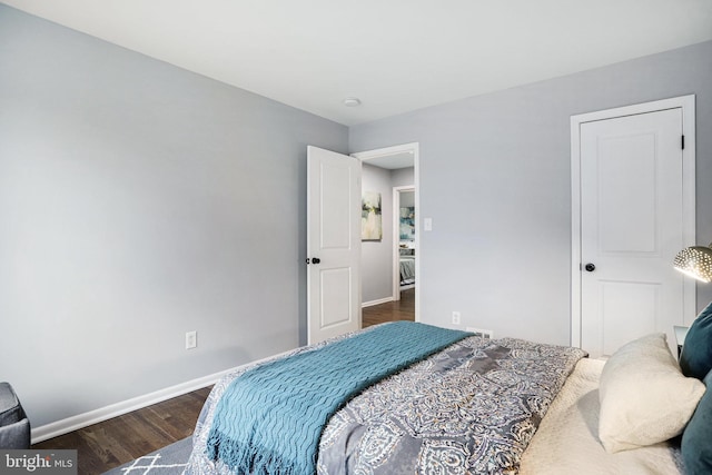 bedroom with dark wood-type flooring