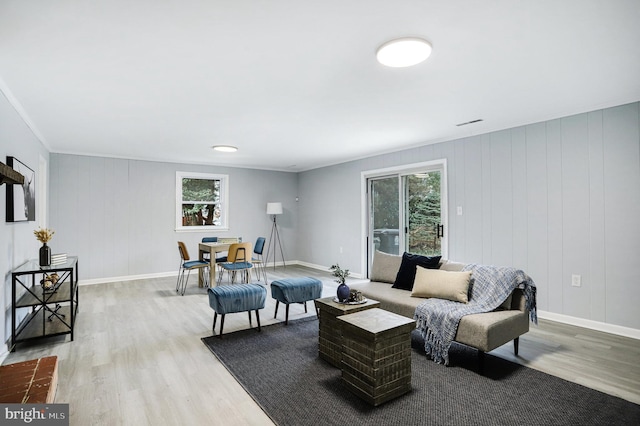 living room featuring crown molding and hardwood / wood-style floors