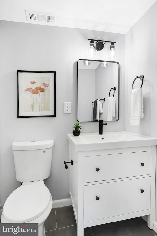 bathroom with vanity, tile patterned floors, and toilet