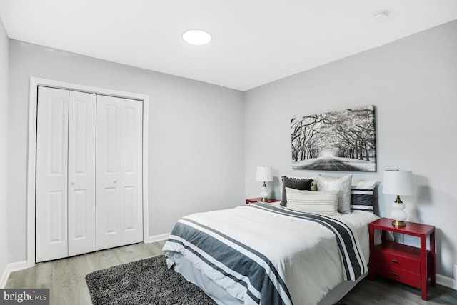 bedroom with wood-type flooring and a closet