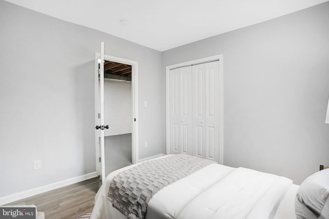 bedroom with hardwood / wood-style floors and a closet