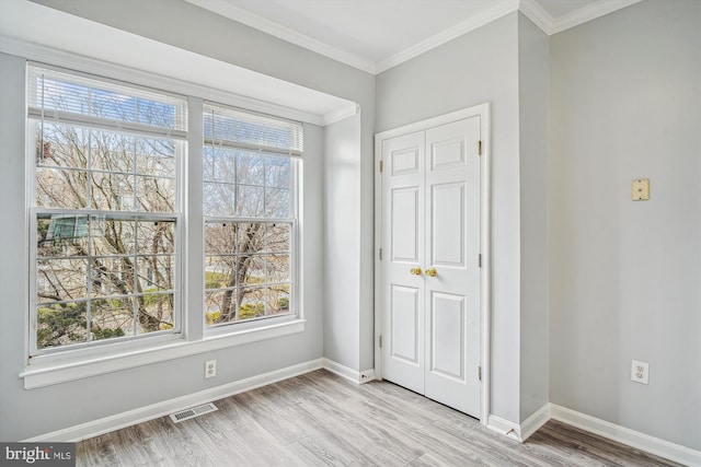 interior space featuring crown molding and light hardwood / wood-style floors