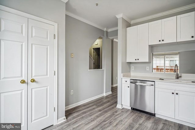 kitchen with white cabinetry, stainless steel dishwasher, ornamental molding, and sink