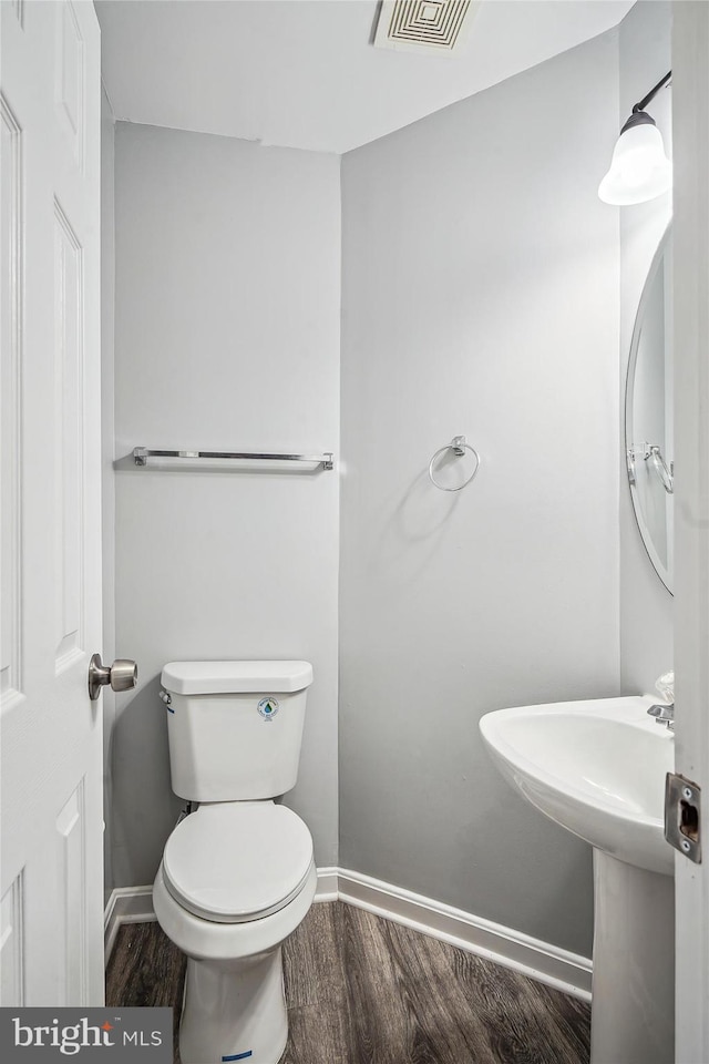 bathroom featuring sink, toilet, and hardwood / wood-style floors