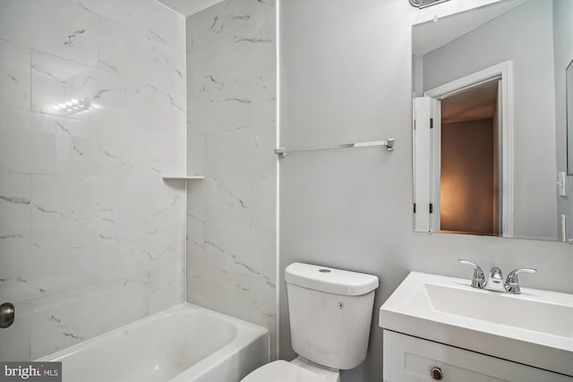 full bathroom featuring tiled shower / bath combo, vanity, and toilet