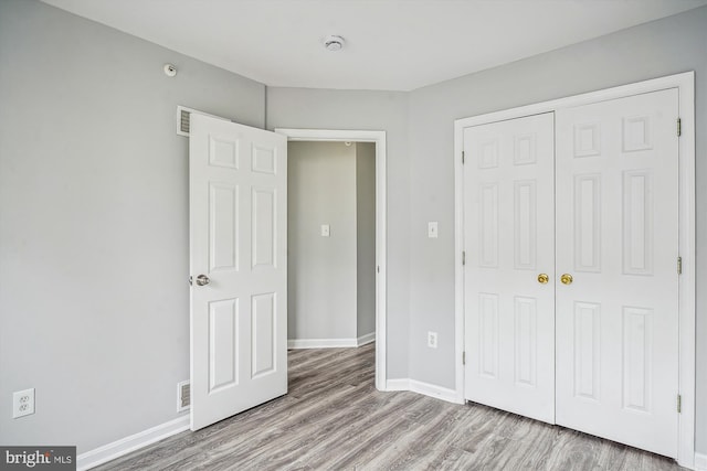 unfurnished bedroom featuring a closet and light hardwood / wood-style flooring