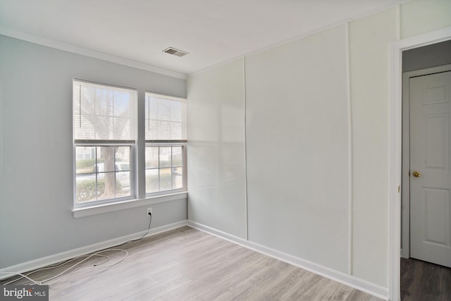 unfurnished room featuring crown molding and hardwood / wood-style flooring