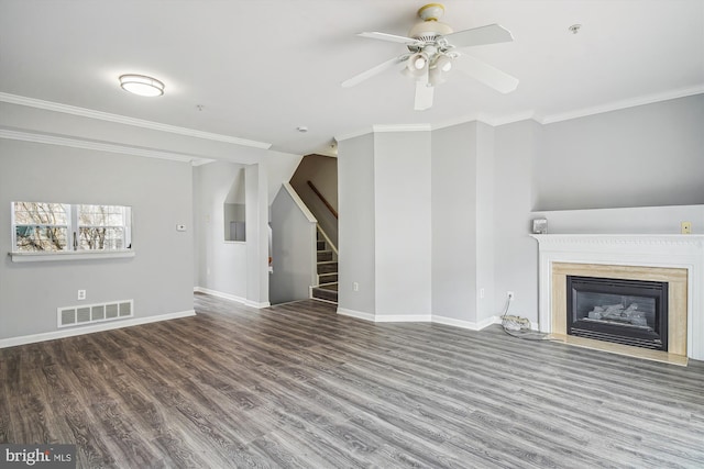 unfurnished living room with hardwood / wood-style flooring, ceiling fan, and ornamental molding