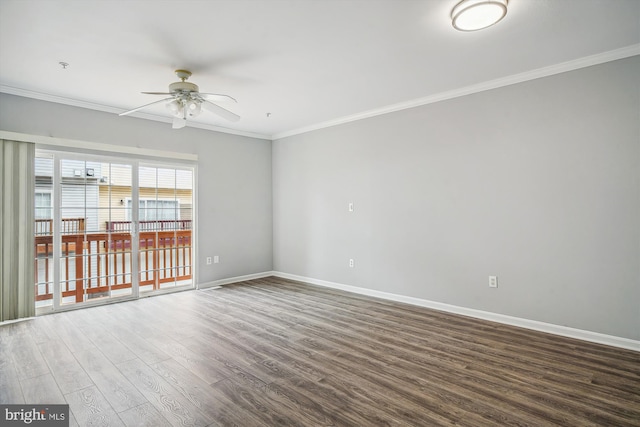 empty room featuring dark hardwood / wood-style flooring, crown molding, and ceiling fan