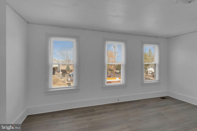 spare room featuring dark hardwood / wood-style flooring