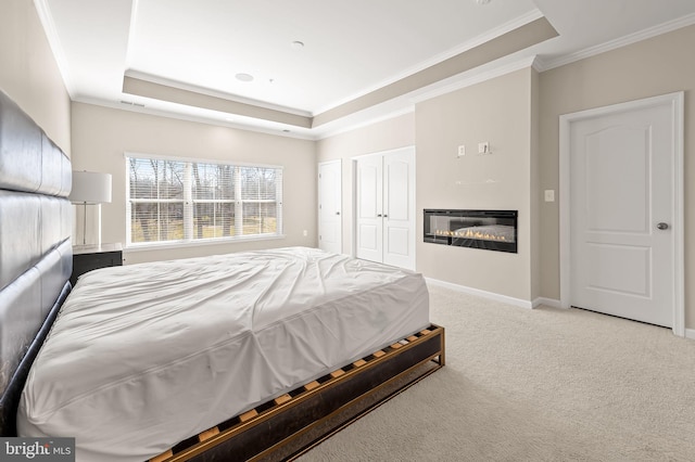 bedroom featuring light colored carpet, ornamental molding, and a raised ceiling